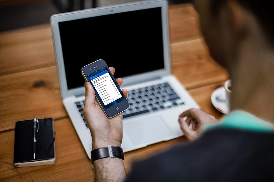 Info Grove App User Looking at Iphone Info Grove App