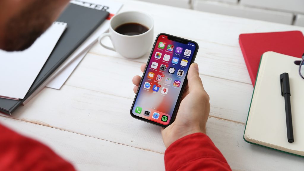 Info Grove App User looking at Iphone Home Page Apps